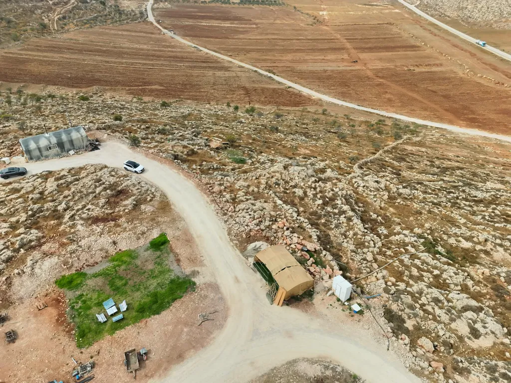 Farm fields and the edge of the farm seen from the air